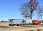 Two hopper cars and a restored Reading Caboose waiting to be coupled to the 0-6-0 9 steam locomotive in Woodstown around the S. Woodstown Station. 